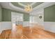 Formal dining room showcasing wainscoting, hardwood floors, and decorative chandelier at 8160 Stone Hill Rd, Cumming, GA 30028