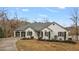 Charming exterior view of a home featuring a well-manicured front yard and a two-car garage at 8160 Stone Hill Rd, Cumming, GA 30028