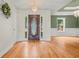 Inviting foyer with hardwood floors, decorative chandelier, and a beautiful front door with sidelights at 8160 Stone Hill Rd, Cumming, GA 30028