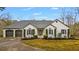 Charming single-story home featuring a two-car garage, manicured lawn, and classic architectural details at 8160 Stone Hill Rd, Cumming, GA 30028