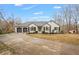 Charming single-story home featuring a two-car garage, manicured lawn, and classic architectural details at 8160 Stone Hill Rd, Cumming, GA 30028