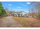 Charming single-story home with a two-car garage, classic architectural details, and a well-manicured front yard at 8160 Stone Hill Rd, Cumming, GA 30028