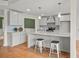 Modern kitchen featuring gray cabinets, an island with seating, and stainless steel appliances at 8160 Stone Hill Rd, Cumming, GA 30028