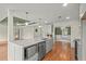 Well-equipped kitchen featuring hardwood floors, gray cabinets, a large island, and modern appliances at 8160 Stone Hill Rd, Cumming, GA 30028