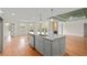 Modern kitchen open to the living room, featuring a central island, stainless steel appliances and lots of cabinet space at 8160 Stone Hill Rd, Cumming, GA 30028