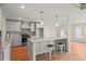 Modern kitchen featuring gray cabinets, stainless steel appliances, a tile backsplash, and a spacious island with bar seating at 8160 Stone Hill Rd, Cumming, GA 30028