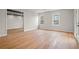 Spacious living room with hardwood floors and natural light streaming through the large windows at 8160 Stone Hill Rd, Cumming, GA 30028