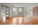 Open living space featuring hardwood floors, a brick accent wall, and plenty of natural light at 8160 Stone Hill Rd, Cumming, GA 30028