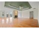 Spacious living room with hardwood floors, stone fireplace, trey ceiling, and access to the outdoor deck at 8160 Stone Hill Rd, Cumming, GA 30028