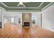 Spacious living room boasts a stone fireplace, hardwood floors, and lots of natural light at 8160 Stone Hill Rd, Cumming, GA 30028