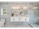 Modern bathroom featuring double sink vanity, glass shower and beautiful tiling at 8160 Stone Hill Rd, Cumming, GA 30028