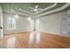 Spacious bedroom with hardwood floors, a green accent ceiling and white trim, complemented by bright windows at 8160 Stone Hill Rd, Cumming, GA 30028