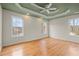 Large bedroom with decorative tray ceiling, ceiling fan, and large windows with great natural light at 8160 Stone Hill Rd, Cumming, GA 30028