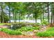 Beautiful backyard featuring pond with water lilies, mulch, and trees overlooking the lake at 312 Flat Shoals Church Rd, Stockbridge, GA 30281