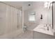 Bright bathroom featuring a shower with tub, toilet, double vanity, and window at 312 Flat Shoals Church Rd, Stockbridge, GA 30281