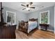 Comfortable bedroom with vintage furniture, ceiling fan and hardwood floors at 312 Flat Shoals Church Rd, Stockbridge, GA 30281