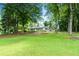 Secluded home featuring a covered porch surrounded by lush greenery on an expansive lawn at 312 Flat Shoals Church Rd, Stockbridge, GA 30281