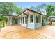 View of the side of the house, with a deck, sunroom, and multiple windows overlooking the lake at 312 Flat Shoals Church Rd, Stockbridge, GA 30281