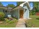 Charming entryway with a decorative front door, small pond, and landscaped surroundings at 312 Flat Shoals Church Rd, Stockbridge, GA 30281