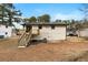 Backyard featuring a small deck with stairs at 6660 Hidden Brook Trl, Atlanta, GA 30349