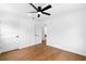 Bright bedroom featuring a ceiling fan, hardwood flooring, and neutral walls at 6660 Hidden Brook Trl, Atlanta, GA 30349