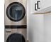Laundry room showcasing a stacked washer and dryer at 6660 Hidden Brook Trl, Atlanta, GA 30349