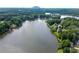 Expansive aerial view of a lake community, showcasing waterfront homes surrounded by lush greenery and scenic views at 7435 Woodruff Way, Stone Mountain, GA 30087