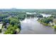 Scenic aerial view of a lake surrounded by homes and lush greenery at 7435 Woodruff Way, Stone Mountain, GA 30087