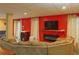 A basement living room, with large couch, fireplace, and large TV at 7435 Woodruff Way, Stone Mountain, GA 30087