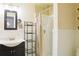 Well-lit bathroom with modern sink, white wainscoting, and stand up shower featuring chrome shower head at 7435 Woodruff Way, Stone Mountain, GA 30087
