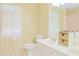 Bright bathroom with a white vanity, double sinks, and a window for natural light at 7435 Woodruff Way, Stone Mountain, GA 30087