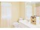 Bright bathroom with a single vanity, mirror, and toilet at 7435 Woodruff Way, Stone Mountain, GA 30087