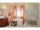 Modern bathroom featuring a glass shower, a free standing tub, and an elegant vanity at 7435 Woodruff Way, Stone Mountain, GA 30087