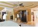 Spacious bedroom featuring a decorative tray ceiling, a ceiling fan, and a large wardrobe at 7435 Woodruff Way, Stone Mountain, GA 30087