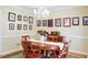 Formal dining room boasting hardwood floors, a chandelier, and a collection of framed photos on display at 7435 Woodruff Way, Stone Mountain, GA 30087