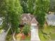 Charming brick home with a two-car garage, arched window, and beautiful landscaping creating curb appeal at 7435 Woodruff Way, Stone Mountain, GA 30087