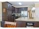 Kitchen featuring granite countertops, stainless steel appliances, and dark cabinets at 7435 Woodruff Way, Stone Mountain, GA 30087