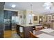 Open kitchen featuring stainless appliances, granite countertops, and dark wood cabinets at 7435 Woodruff Way, Stone Mountain, GA 30087
