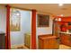 Basement kitchenette with stainless steel appliances, open shelving and adjacent dining space with seating at 7435 Woodruff Way, Stone Mountain, GA 30087