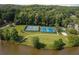 Aerial view featuring lake community tennis courts with landscaping at 7435 Woodruff Way, Stone Mountain, GA 30087