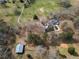 Aerial view of property showing home, outbuildings, pool, and surrounding acreage, offering a private retreat at 75 Price Dr, Locust Grove, GA 30248