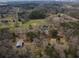 Aerial view of property showing home and surrounding acreage, offering a private retreat in wooded area at 75 Price Dr, Locust Grove, GA 30248