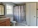 Bathroom featuring a shower with striped curtain, vanity, and a window at 75 Price Dr, Locust Grove, GA 30248