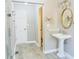 Well-lit bathroom featuring a pedestal sink, gold mirror, modern fixtures, and a glass shower at 75 Price Dr, Locust Grove, GA 30248