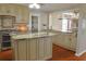 Full kitchen showcasing an island, stainless appliances, light-colored cabinetry, and hardwood floors at 75 Price Dr, Locust Grove, GA 30248
