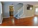 Open-concept living area with hardwood floors and staircase, seamlessly connecting to other rooms at 75 Price Dr, Locust Grove, GA 30248