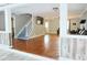 Open-concept living room with hardwood floors, staircase, and comfortable seating area at 75 Price Dr, Locust Grove, GA 30248