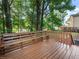 Wooden backyard deck surrounded by mature trees offering lots of shade at 975 Memory Ln, Lawrenceville, GA 30044