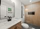 Modern bathroom features a glass shower door and stylish black and white flooring at 975 Memory Ln, Lawrenceville, GA 30044