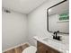 Half bath with new vanity, granite countertop, and modern fixtures at 975 Memory Ln, Lawrenceville, GA 30044
